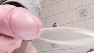 Close-up side view soft dick peeing a hard steady jet of pee