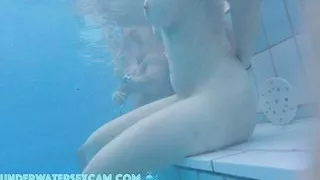 This lovely girl shows her big tits underwater in the pool while the cam is watching her!