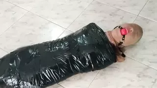 Tape Mummified Girl in Pantyhose Hooded And Ball Gagged