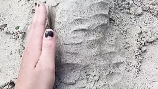 Penis sex art in the summer on a beach