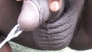Indian Black Guy using Piss to refresh himself outdoors