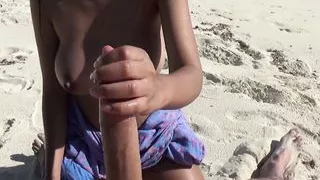 Hot Asian girlfriend shows her tits and jerks cock on beach