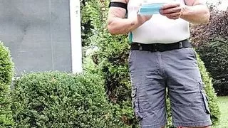 Daddy gardener doing yard work and hosing off