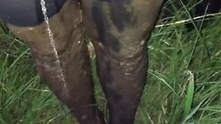 Peeing mud off my pantyhose legs outside.