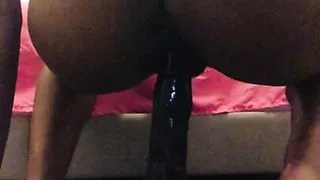Petite Ebony slut gives 12 inch dildo a ride