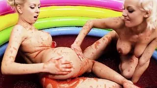 Barbie looking blonde lesbians with big fake tits rubbing each other in a pool full of jelly
