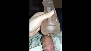 A young boy plays with his huge and thick dick until he cums in a toy