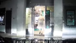 maid dressed under transparent raincoat to cash dipenser