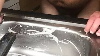 Cleaning the sink with nipple clamps on - like a good slave should