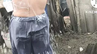 Indian house wife bathing outside