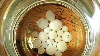 Cumming in a glass of sunflower oil