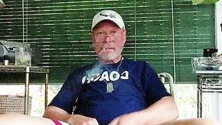 Coach after practice enjoying a cigarvand getting off