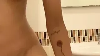 Asian girl putting lotion on after taking a shower