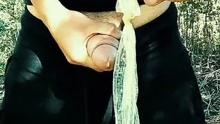 Twink is jerking with used condom UNDER foreskin outdoor