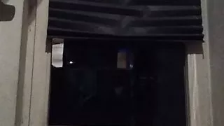 Sissy crossdresser smoking on the balcony