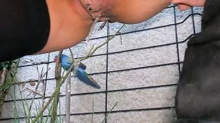 Cute mom pissing standing outside in flowers close up