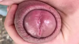 Close up look on glans with precum and close up cum leaking - uncut cock