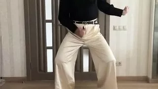 Sissy gay in satin silk palazzo wide leg trousers and black romantic women blouse on high heels overknee boots dancing