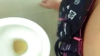 Tattooed twink is pissing in waterpark piss filled toilet