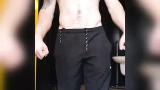 muscular guy tense up after the gym