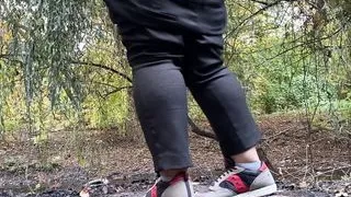 MILF dressed in pants pissing in public outdoors