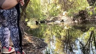 MILF dressed in leggings pissing in the river
