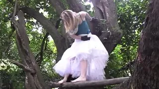 crazy slut climbs a tree and wildly rubs her pussy on the branch