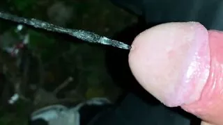 Slowmotion and close up - Unwashed uncut cock piss on the ground outdoor - long piss stream