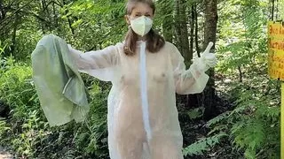 Girl in transparent overalls clean up trash in public