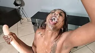 Indian whore plays with her spit as she deepthroats herself with a double sided dildo